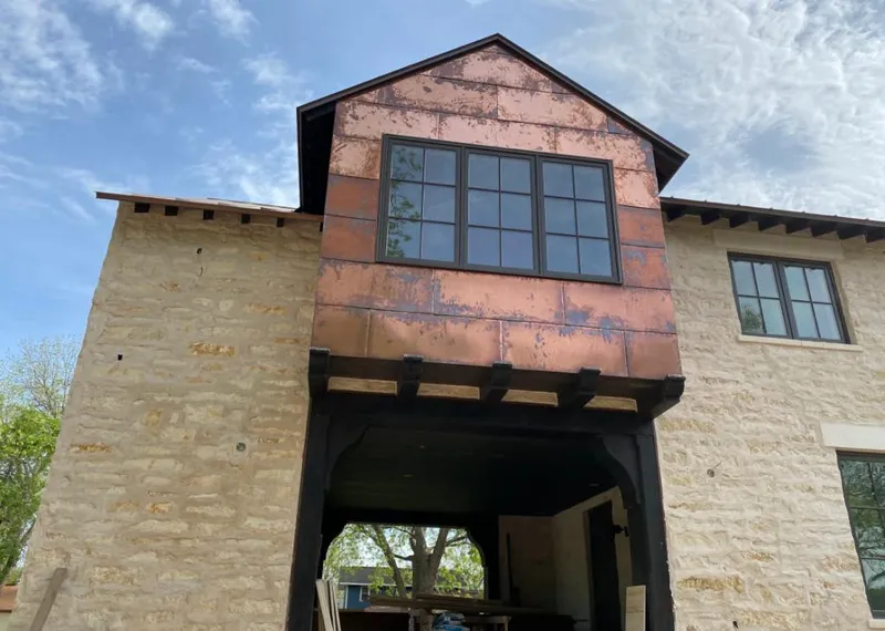 Copper metal panel facade on a stone building for Skylight Installation in Plainfield